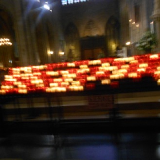 The candles inside of Notre Dame Cathedral Paris